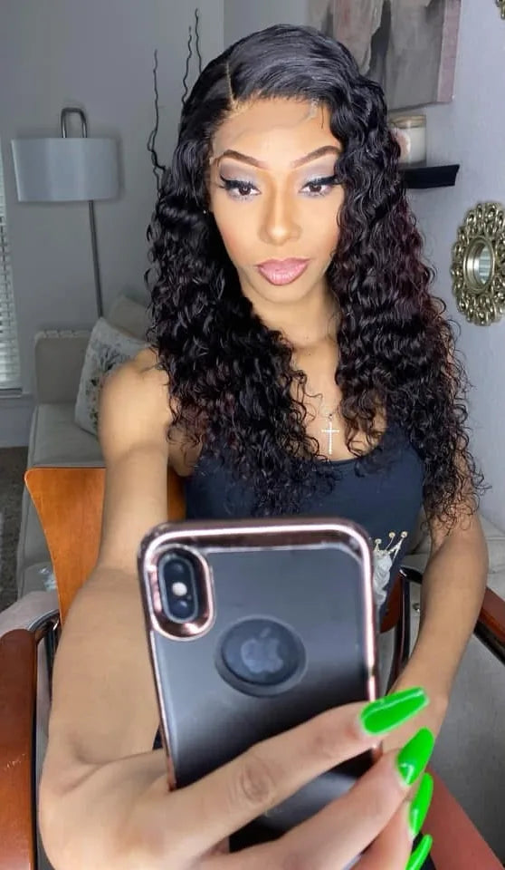 Woman wearing a long curly Lavish Queen wig
